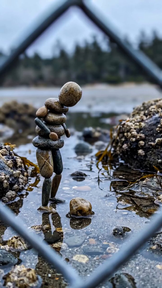 Pebble Figure Kicks Stone